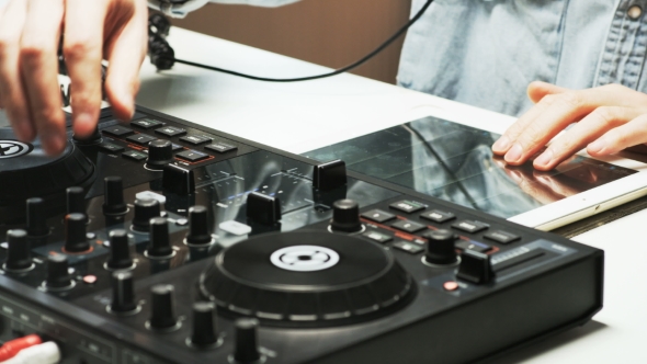 Disc Jockey's Hands While He Changes Settings of the Sound Control System alt