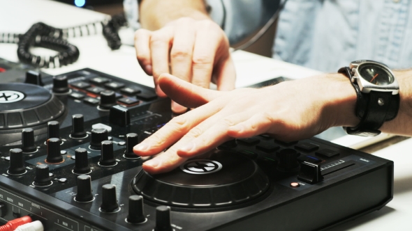 Disc Jockey's Hands While He Changes Settings of the Sound Control System alt