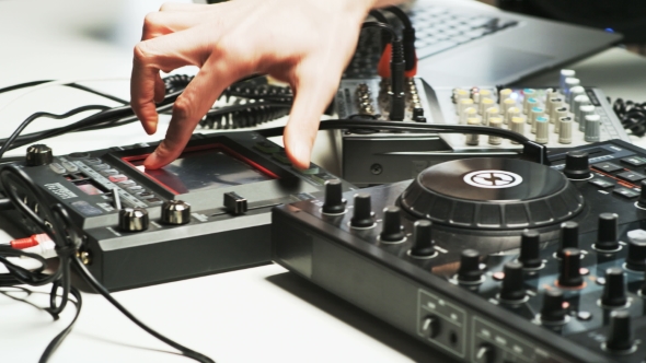 Disc Jockey's Hands While He Changes Settings of the Sound Control System alt