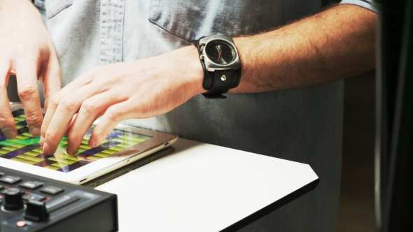 Disc Jockey's Hands While He Changes Settings of the Sound Control System alt