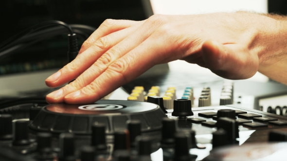 Disc Jockey's Hand While He Changes Settings of the Sound Control System alt