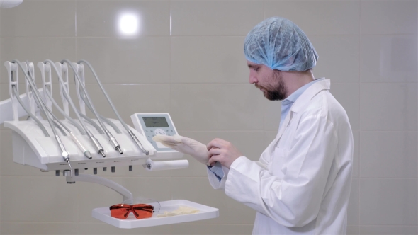Dentist Man Doctor Wearing Medical Gloves in Clinic Cabinet, Modern Hospital. alt