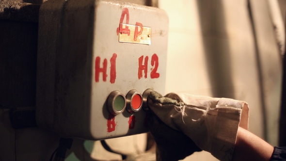 The Woman Presses Industrial Button alt