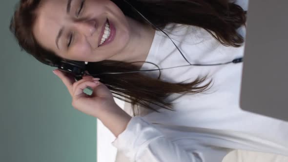 Vertical Shot Beautiful Girl in Pajamas and Wireless Headphones Dancing and Singing in Bed