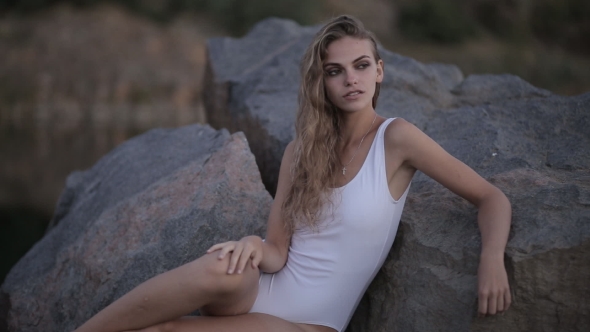 Beautiful Young Girl in a Bikini on the Lake