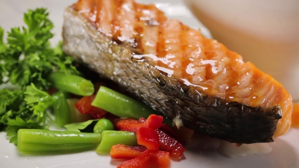 Juicing the Lemon Juice on the Prepared Salmon