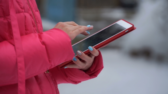 Footage Woman Using Tablet Outdoors in Winter alt