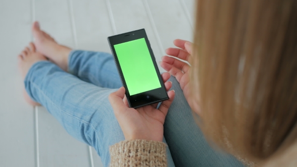 Woman Using Smartphone with Green Screen alt