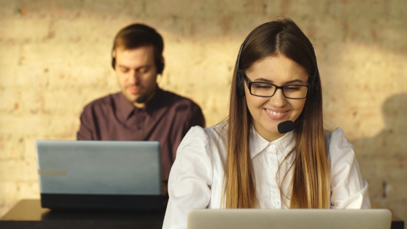 Man and Woman in Headphones Working in Call Center alt