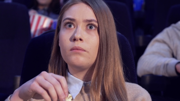 Girl Frowns at the Movie Theater alt