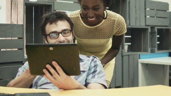 Man Using Tablet at Work and Making Call Over It alt