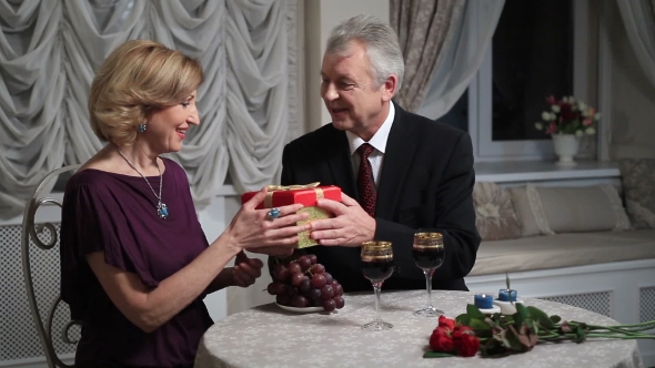 Handsome Senior Man Giving Present To His Wife alt