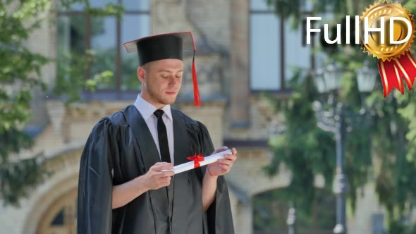 Graduand in Mantle Thinking Holding His Diploma alt