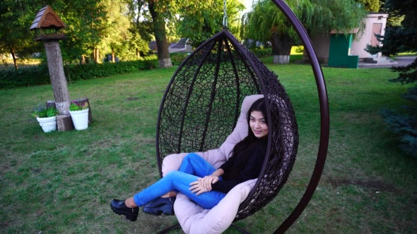 Modern Young Girl Swinging in Hanging Chair