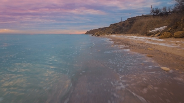 Epic Flying Drone To Over the Winter Beach During a Beautiful Pink Sunset. . alt