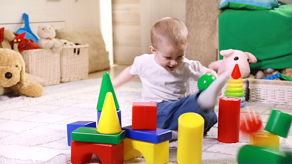 Little Boy Playing With Plastic Blocks