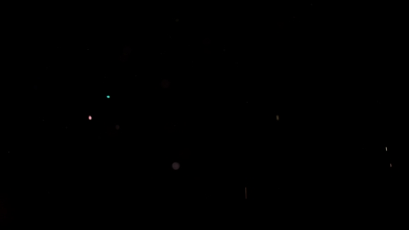 Particles Flying on a Black Background. Colored Particles Flying Erratically