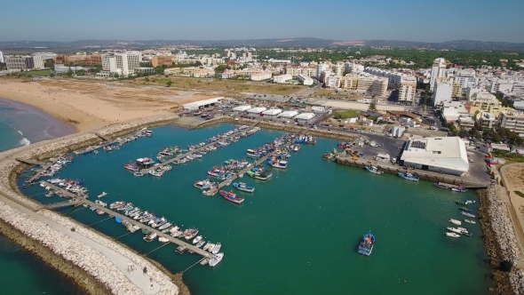 Aerial. Fishing Port and Moored Ships Town Quarteira. alt