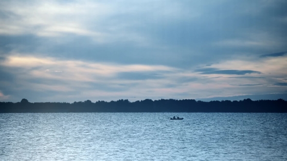 Silhouette of a Boat at Dusk on River