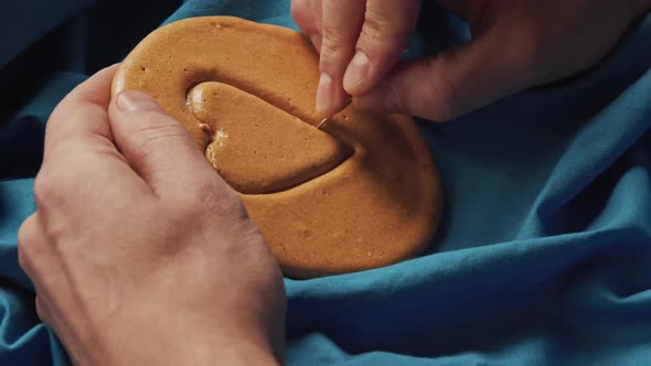 Men's Hands Scratch Sugar Cookies Candy in the Shape of a Heart