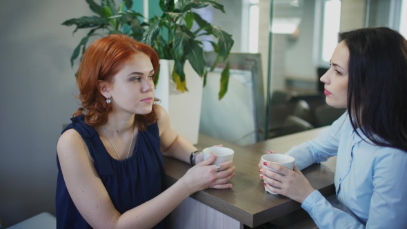 Two Young Beautiful Women Talk Over Cup of Coffee alt