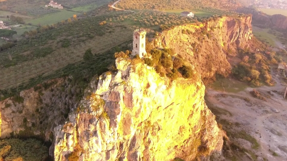 Aerial Shot, Upezzinghi Tower on the Rocky Outcrop in Italy, Tuscany, on the Sunset Light, Filmed