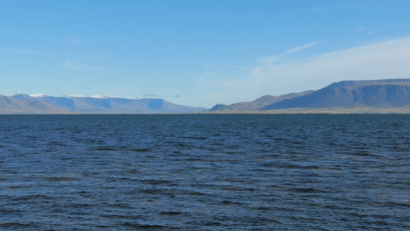 View of Atlantic Ocean Water Near Reykjavik Coast To Hvalfjordur and Mountains in Sunny Day