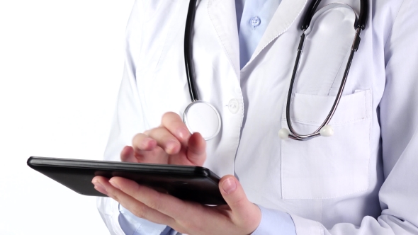 Doctor Standing and Holding Tablet Compute, Wearing Stethoscope, on White alt