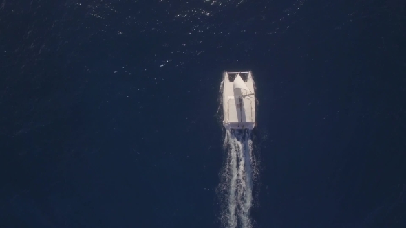 Aerial Top View of Sailing White Yacht in Empty Ocean Blue Water, Mauritius Island alt