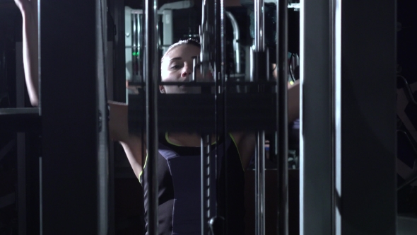 Attractive Woman in the Gym Doing Pulldown Exercises To Front in Silhouette alt