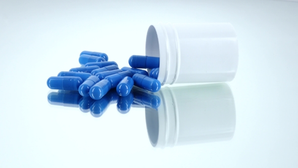 Medicine Blue Pills in a Bottle, on White, Rotation, Reflection, Stock ...