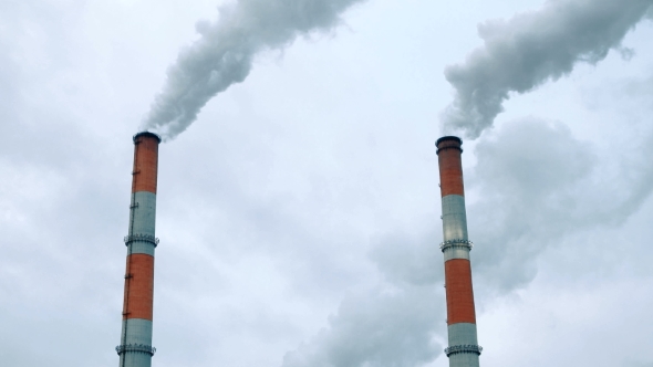 Boiler House Chimney. Steam Against the Cloudy Snowy Sky alt