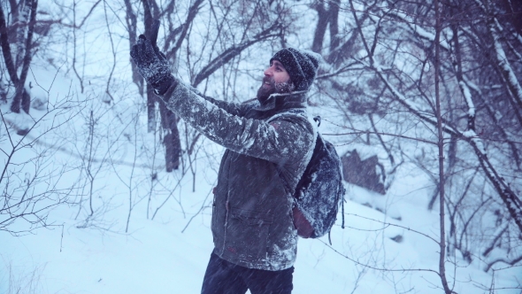Bearded Man Making Selfie in Snowy Wood alt