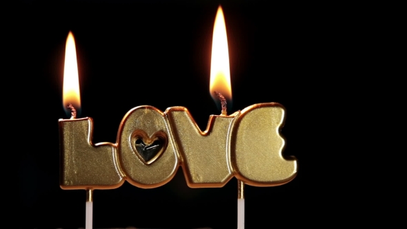 Cake with the Word Love and Burning Candles