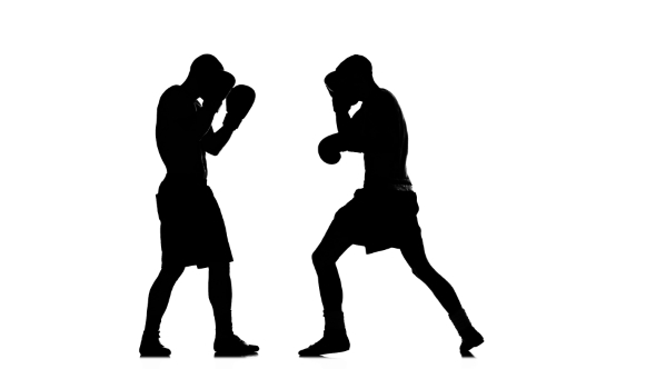 Two Young Fighters Train Left Hook To the Head. Silhouette alt