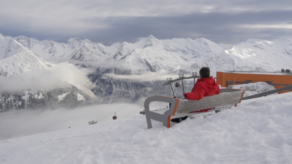 Tired Skier Resting on the Bench