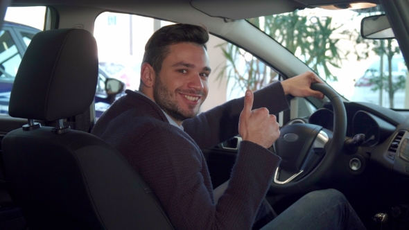 Man Shows His Thumb Up Inside the Car alt
