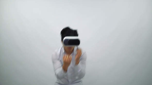 Young Man Fights in Virtual Reality Glasses on a White Background
