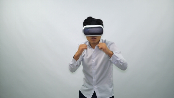Man Fights in Virtual Reality Glasses on a White Background