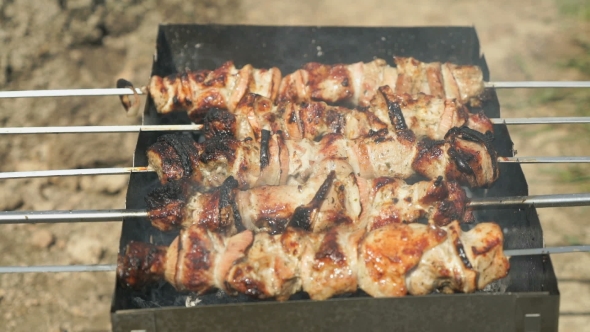 Frying of Marinated Meat on Metal Skewers on Coals