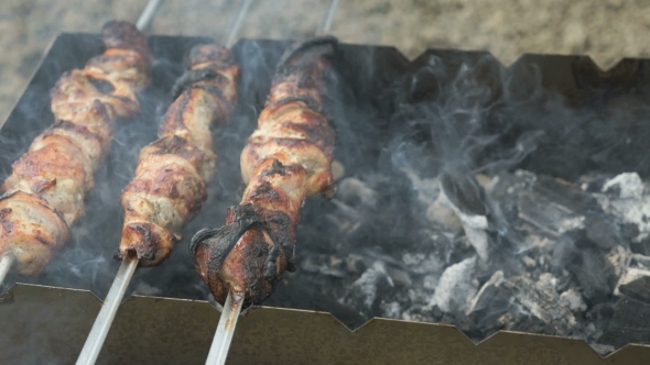 Meat Are Prepared on the Metal Skewers on a Grill