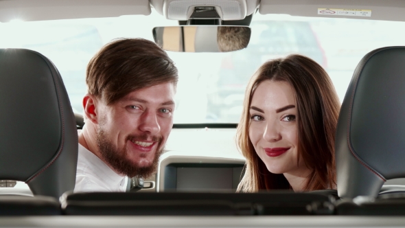 Couple Turns Their Faces To The Back Seat Inside The Car By Kotlyarn