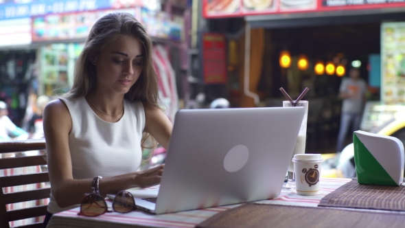 Young Woman Working With Laptop With Joyful Smile alt