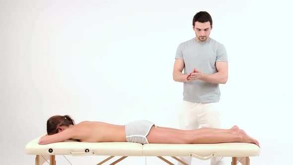 Male Masseur Preparing for Work. Massage Therapist Oiling Hands alt