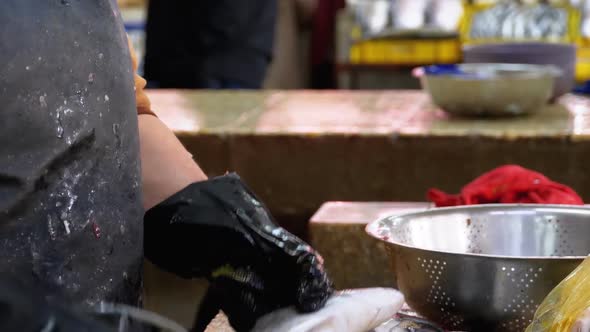 Cutting Fish in Market Stall. Woman Manual Cleaning and Cuts Fresh Fish alt