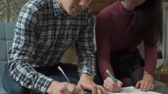Close-up of Caucasian Young Hands Completing Questionnaires or Forms alt