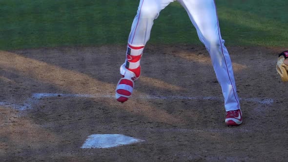 A baseball player batter makes a play at a game. alt