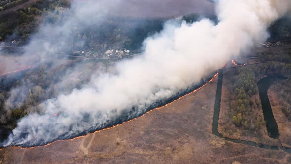 Aerial top view of smoking Wild Fire. Flying above large smoke clouds. Forest deforestation alt
