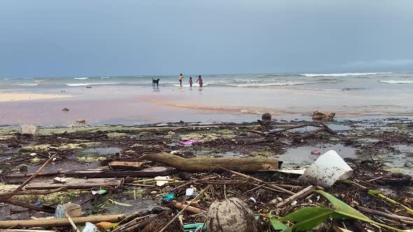 Ocean Pollution. Save Planet For Next Generation. Kids And Dog Playing On Wasted Beach alt