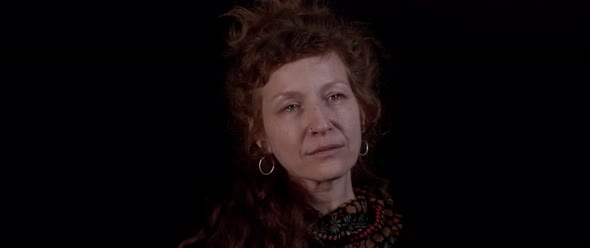 Redhead woman gazes in tears of sadness in slow motion